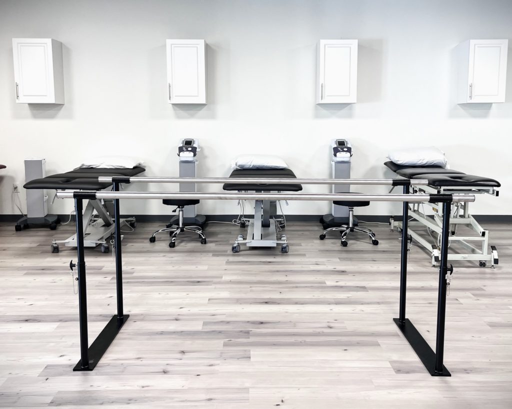 physical therapy treatment tables and parallel bars